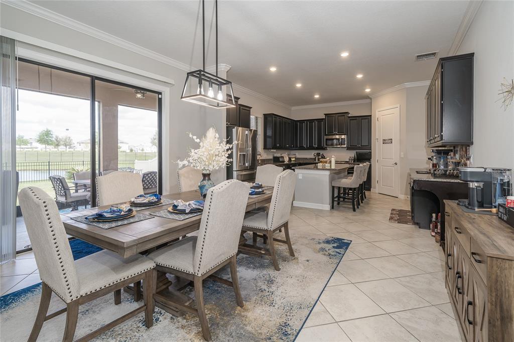 8099 Lago Mist Way Wesley Chapel, FL 33545 - Photo 15 of 56 a view of a dining room with furniture window and outside view