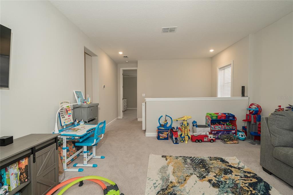 8099 Lago Mist Way Wesley Chapel, FL 33545 - Photo 18 of 56 a room with toys and a wooden floor