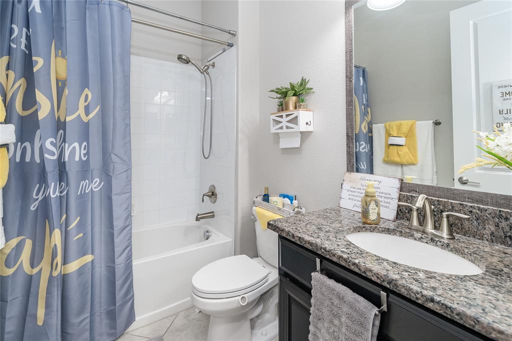 8099 Lago Mist Way Wesley Chapel, FL 33545 - Photo 29 of 56 a bathroom with a granite countertop sink and a mirror