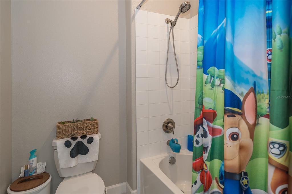 8099 Lago Mist Way Wesley Chapel, FL 33545 - Photo 34 of 56 a bathroom with a window and a bathtub