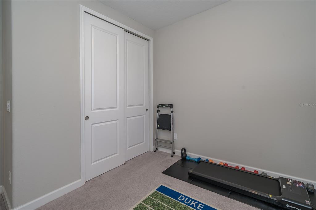8099 Lago Mist Way Wesley Chapel, FL 33545 - Photo 35 of 56 a room with a window and a book shelf