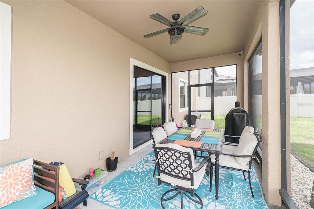 8099 Lago Mist Way Wesley Chapel, FL 33545 - Photo 37 of 56 a living room with furniture and a floor to ceiling window