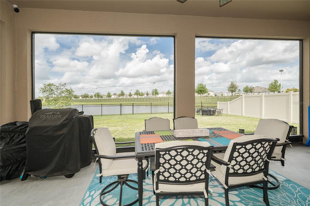 8099 Lago Mist Way Wesley Chapel, FL 33545 - Photo 38 of 56 a dining room with furniture and a floor to ceiling window