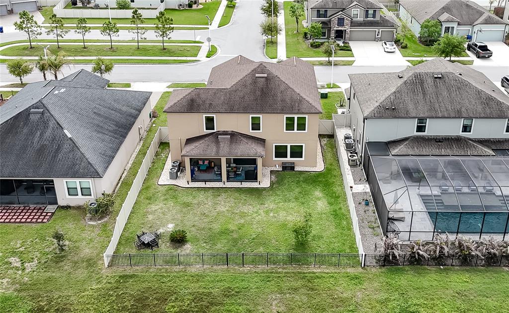 8099 Lago Mist Way Wesley Chapel, FL 33545 - Photo 42 of 56 an aerial view of a house with a yard