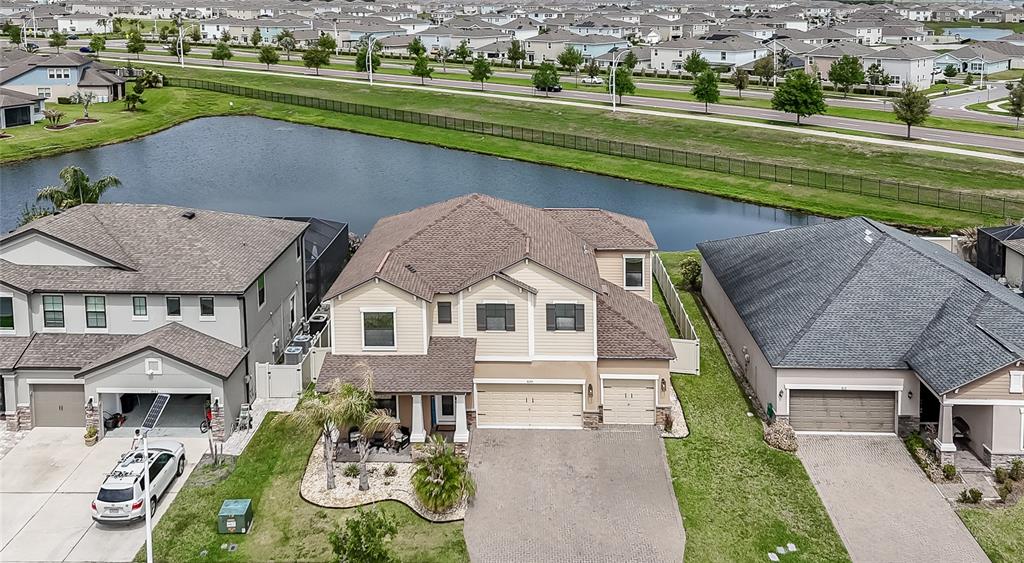 8099 Lago Mist Way Wesley Chapel, FL 33545 - Photo 47 of 56 an aerial view of a house with a garden and lake view