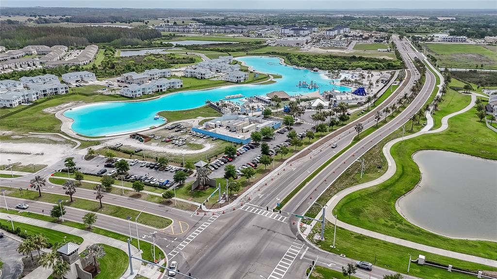 8099 Lago Mist Way Wesley Chapel, FL 33545 - Photo 50 of 56 an aerial view of a swimming pool a yard and lake view