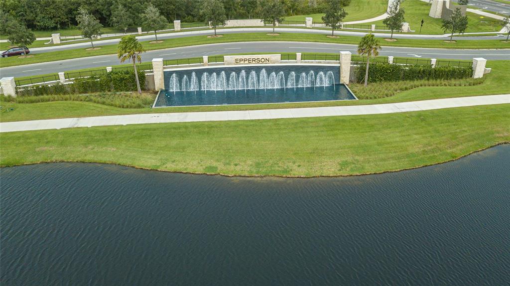 8099 Lago Mist Way Wesley Chapel, FL 33545 - Photo 54 of 56 a view of a big yard with a large pool of the house