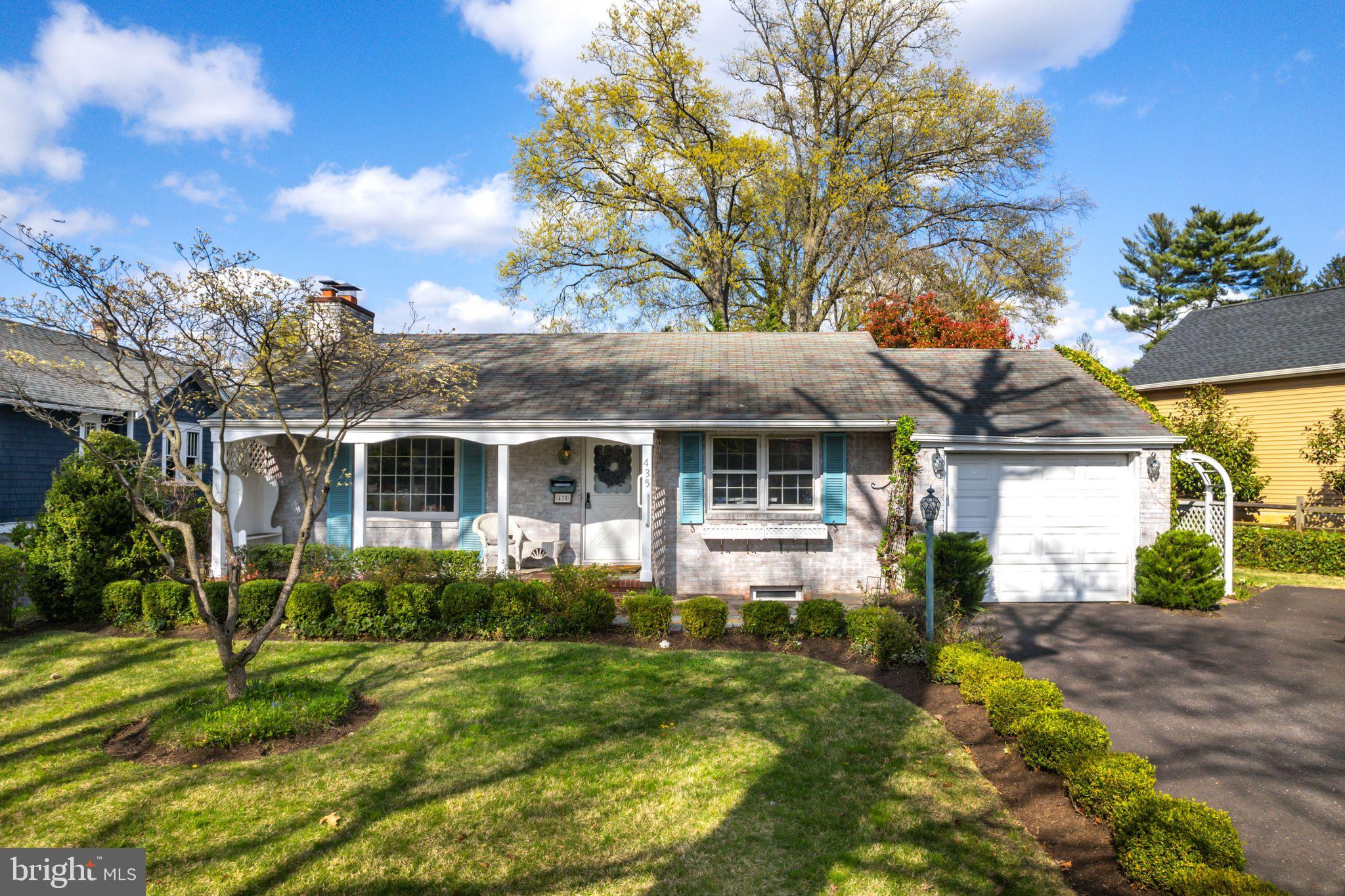 a front view of house with yard and green space