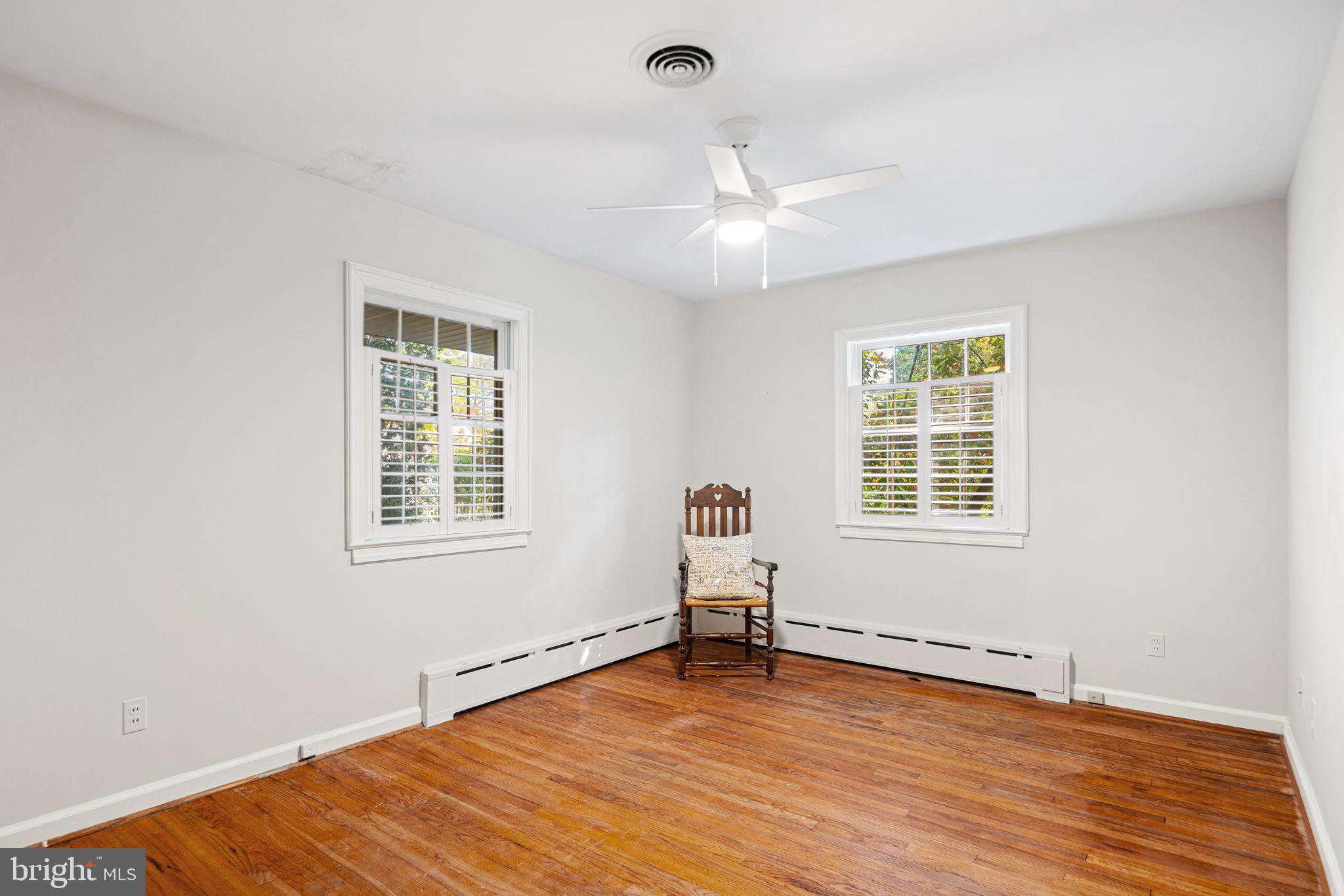 435 1st Avenue Haddon Heights, NJ 08035 - Photo 11 of 19 an empty room with wooden floor fan and windows