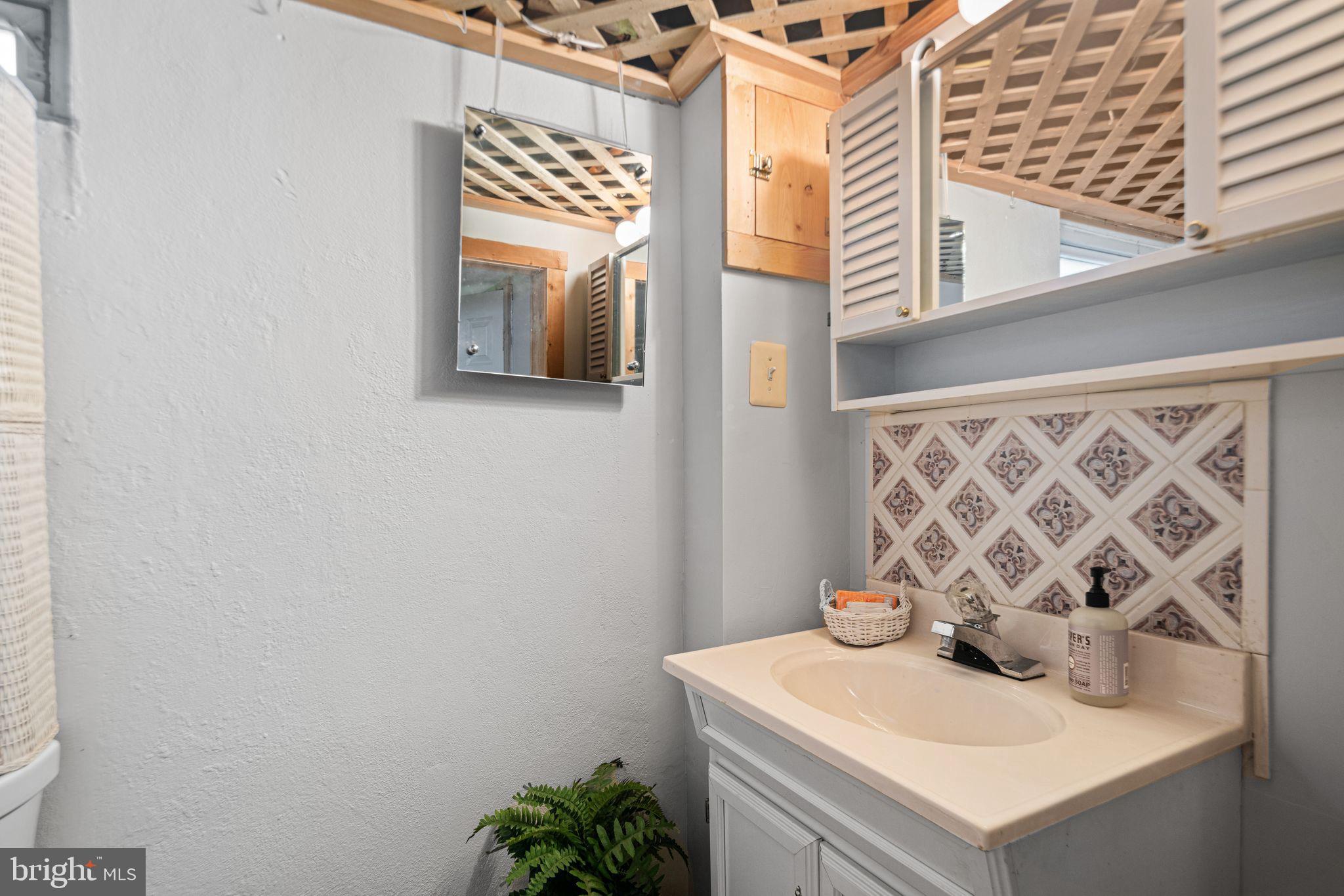435 1st Avenue Haddon Heights, NJ 08035 - Photo 16 of 19 a bathroom with a sink and a mirror