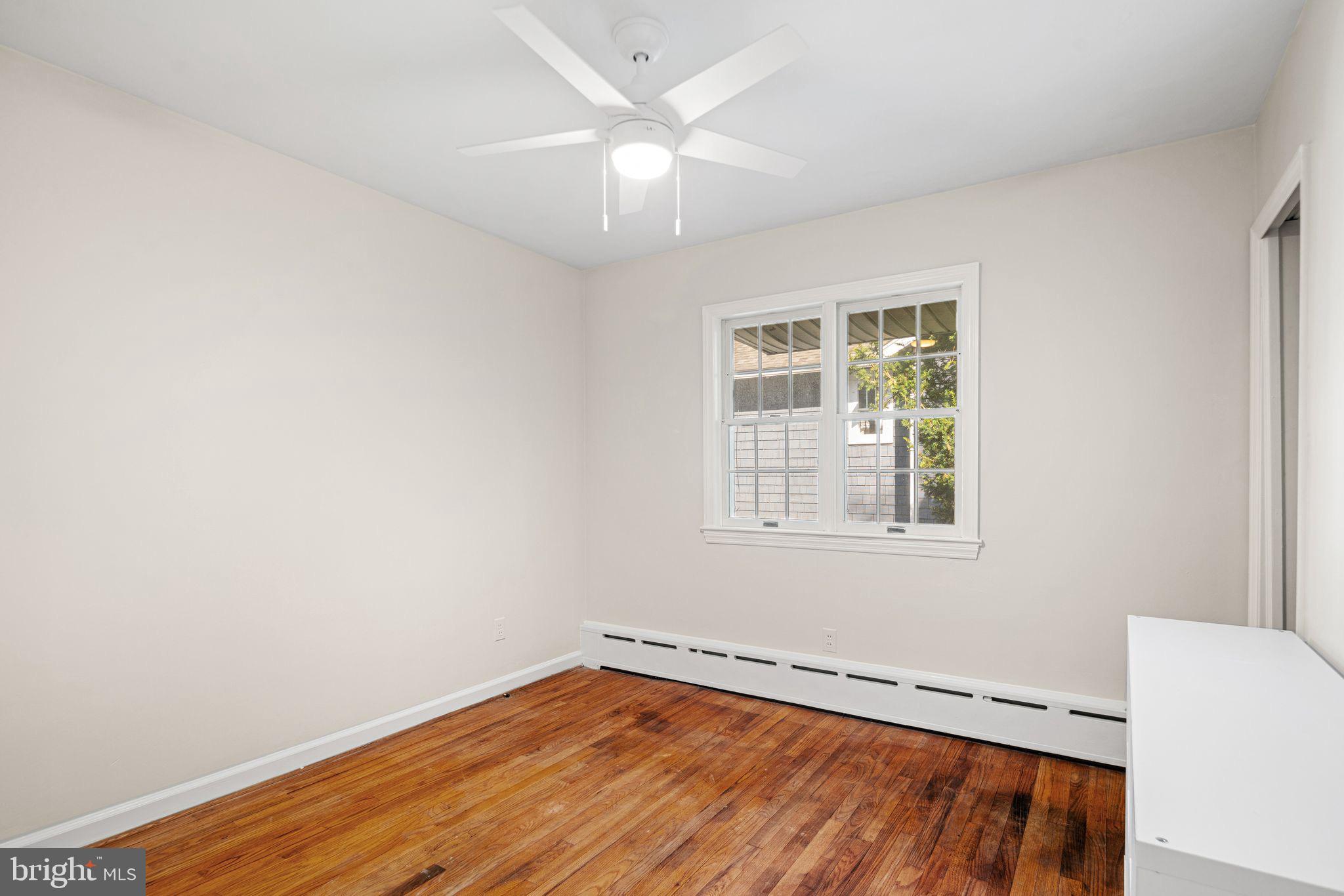 435 1st Avenue Haddon Heights, NJ 08035 - Photo 9 of 19 an empty room with a window and wooden floor