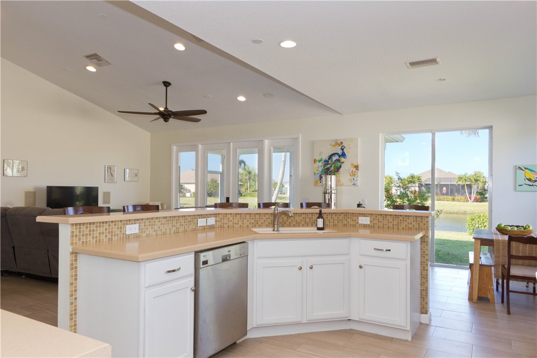 628 Tangelo Circle Southwest Vero Beach, FL 32968 - Photo 11 of 36 a view of a kitchen counter space a sink appliances and cabinets