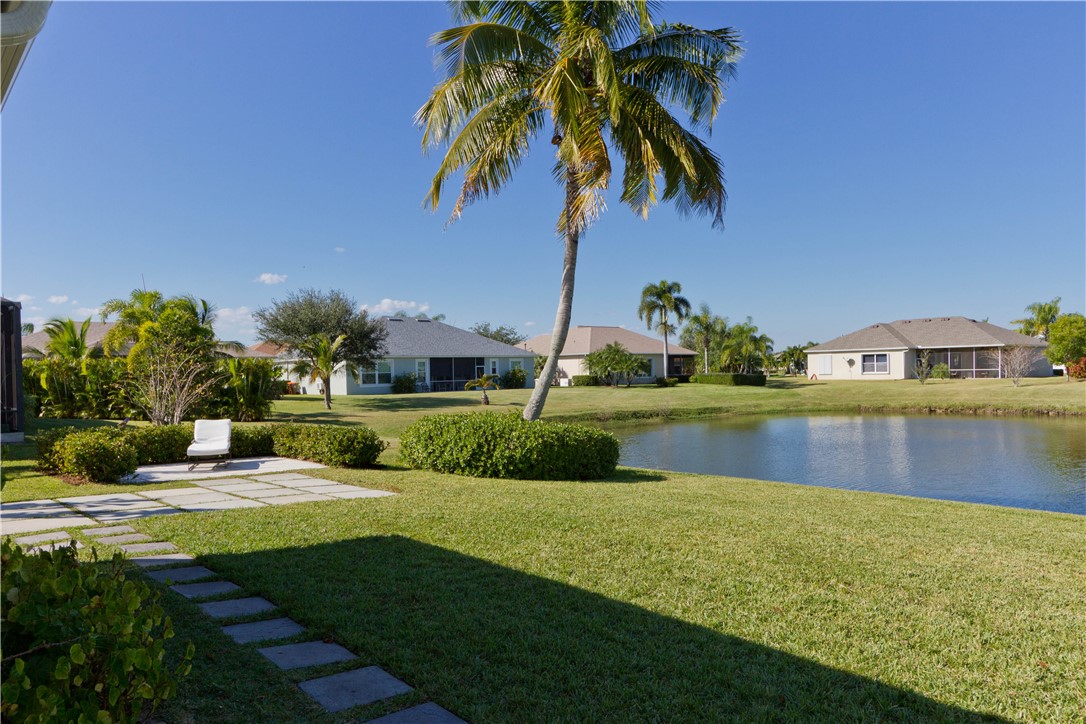 628 Tangelo Circle Southwest Vero Beach, FL 32968 - Photo 28 of 36 a view of a swimming pool with a garden and plants