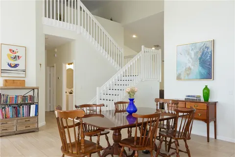 a view of a dining room with furniture and a book shelf