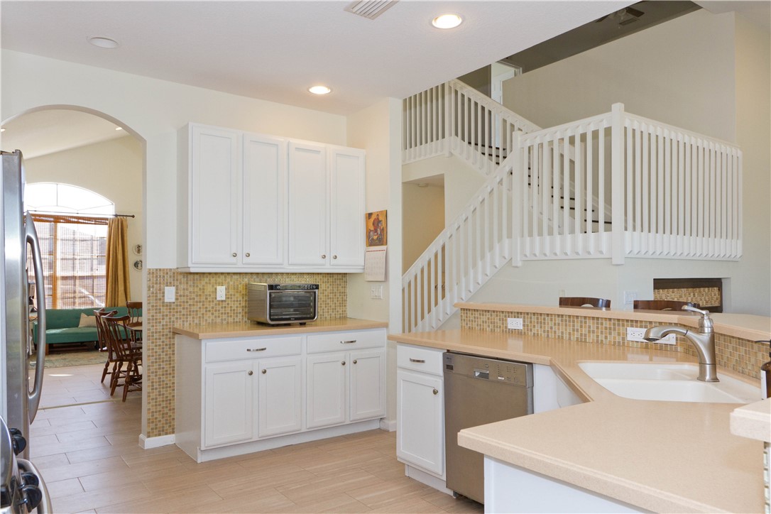 628 Tangelo Circle Southwest Vero Beach, FL 32968 - Photo 8 of 36 a kitchen with a sink a stove cabinets and wooden floor