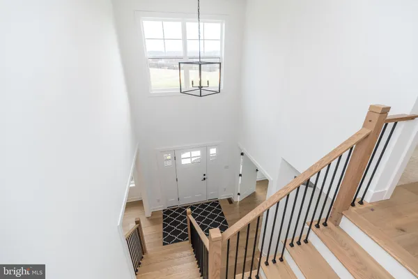 a view of a livingroom with wooden floor and staircase