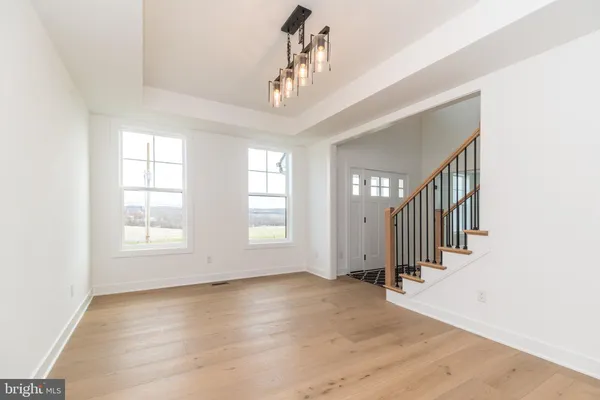 a kitchen with stainless steel appliances granite countertop a sink a stove and a wooden floors