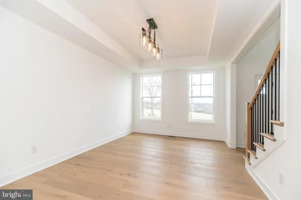 a view of a kitchen with a sink and wooden floor