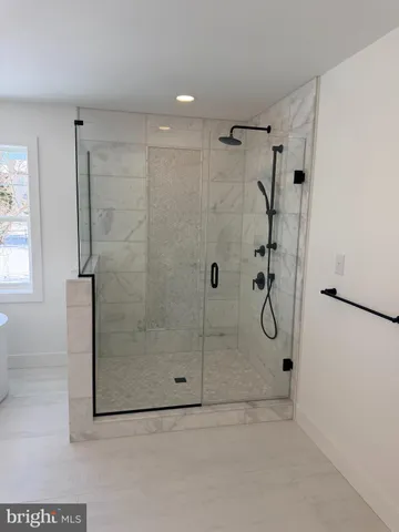 a bathroom with a glass shower door
