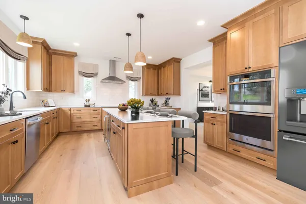 a view of a kitchen with a sink and a refrigerator