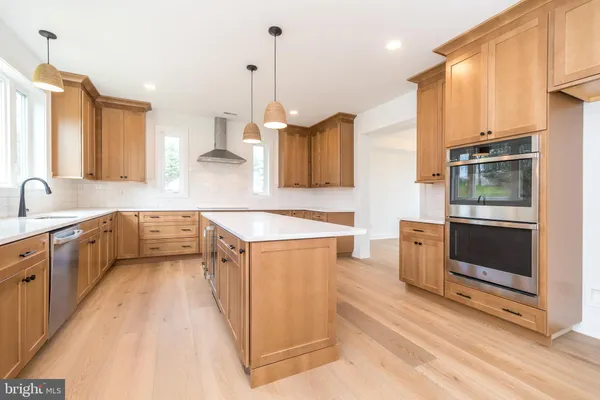 a view of a kitchen with a sink and a refrigerator