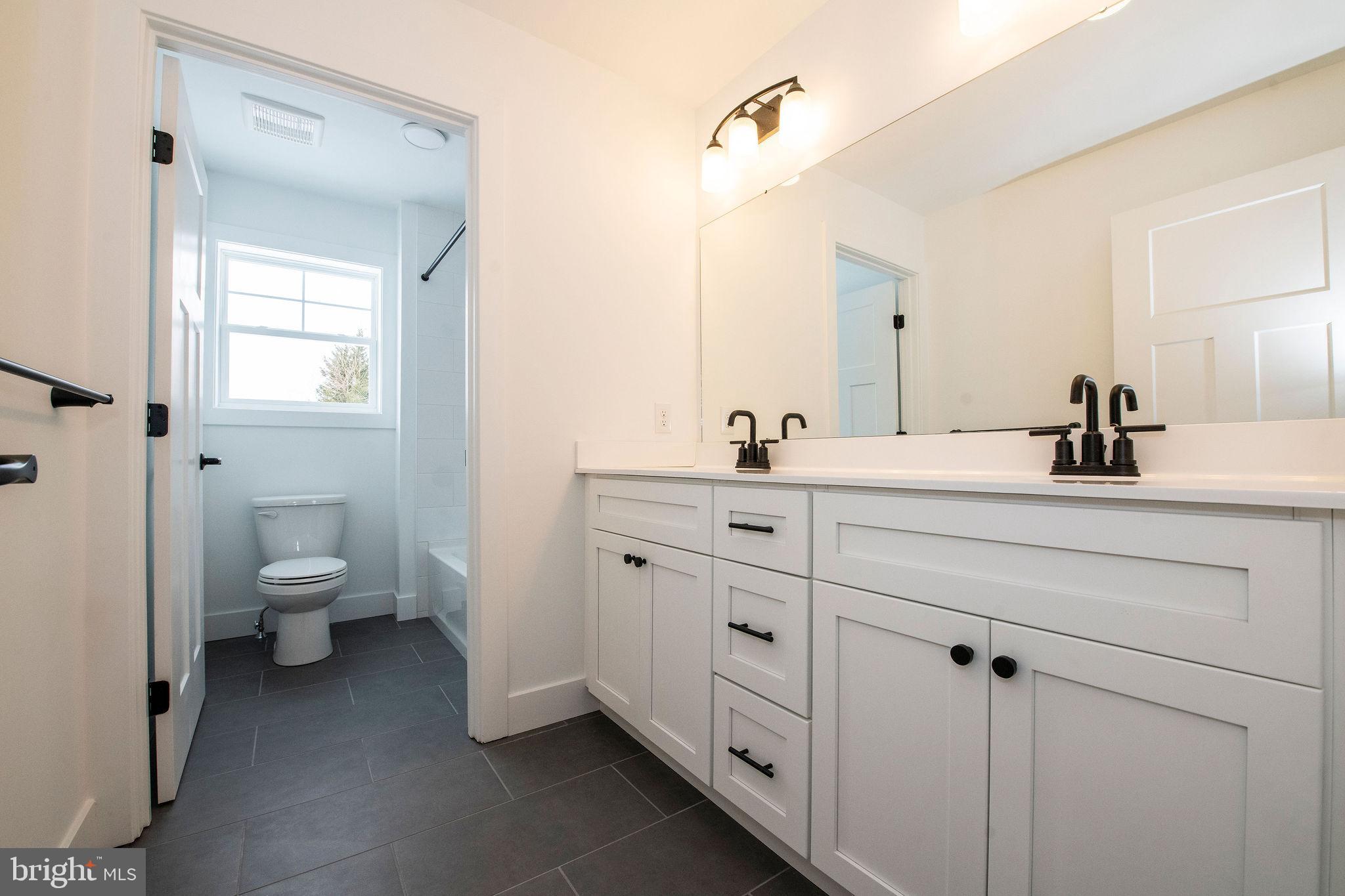 209 Old State Road Royersford, PA 19468 - Photo 27 of 29 a bathroom with a double vanity sink toilet and shower