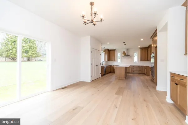 an empty room with windows and cabinet