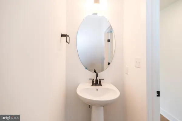 a bathroom with a bathtub shower sink and mirror