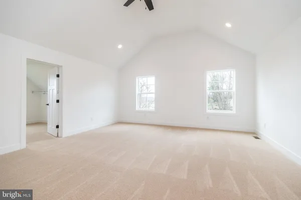 an empty room with windows and closet