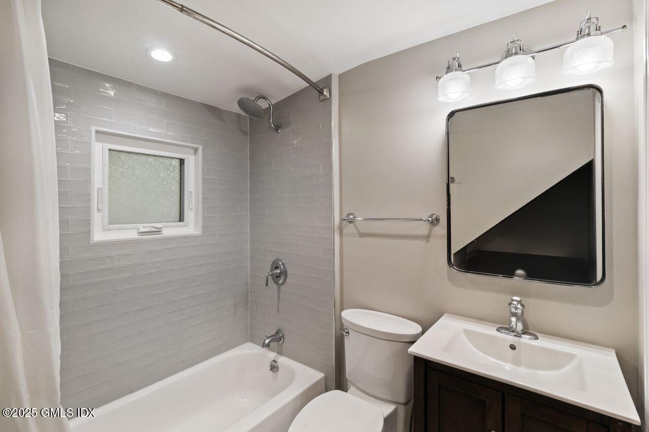 207 Sheep Hill Road Riverside, CT 06878 - Photo 11 of 18 a bathroom with a toilet sink and mirror