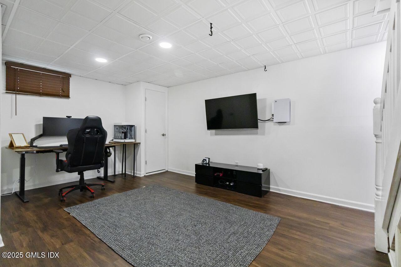 207 Sheep Hill Road Riverside, CT 06878 - Photo 12 of 18 a view of a livingroom with workspace and a flat screen tv