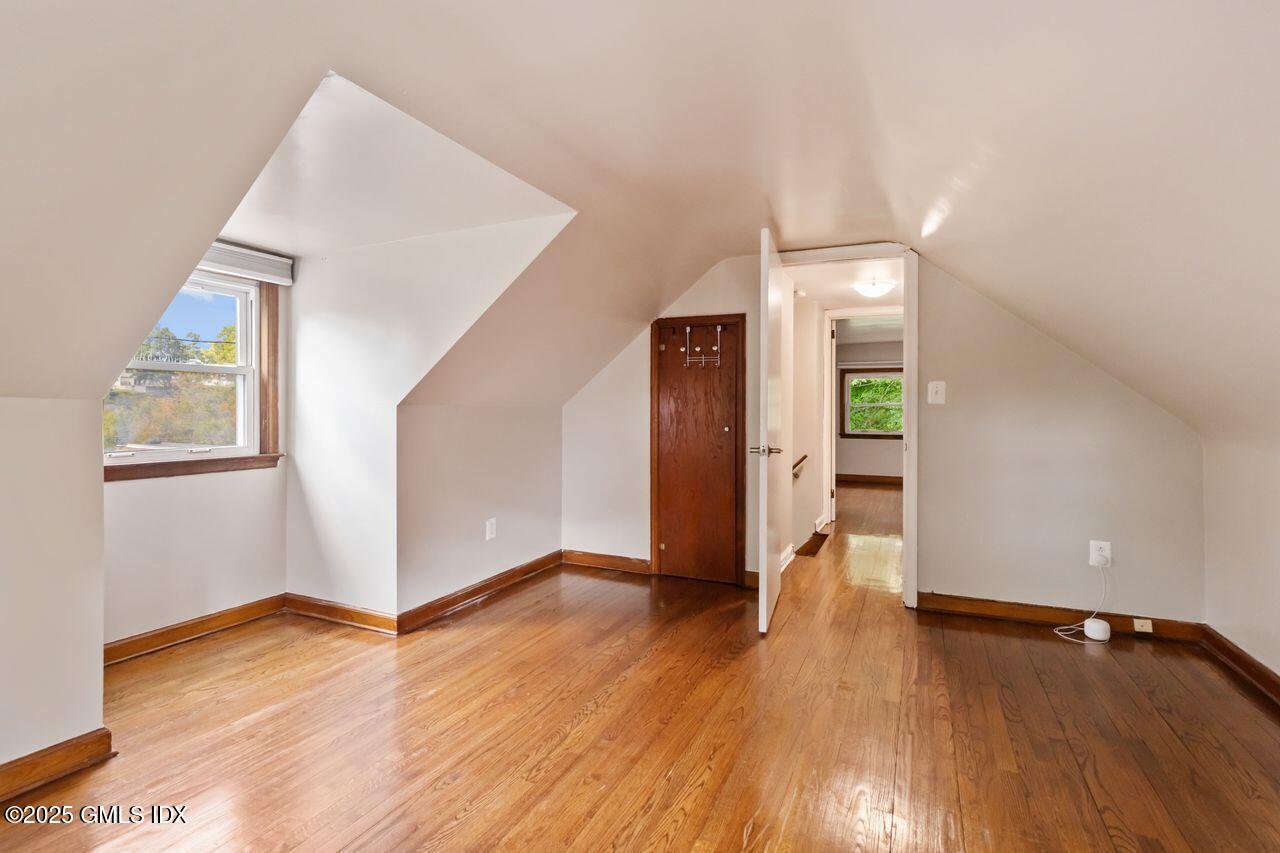 207 Sheep Hill Road Riverside, CT 06878 - Photo 16 of 18 a view of an empty room with wooden floor and a window