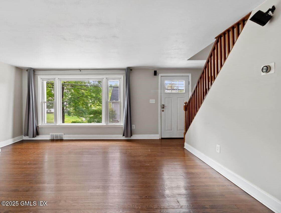 207 Sheep Hill Road Riverside, CT 06878 - Photo 4 of 18 a view of empty room with wooden floor and fan
