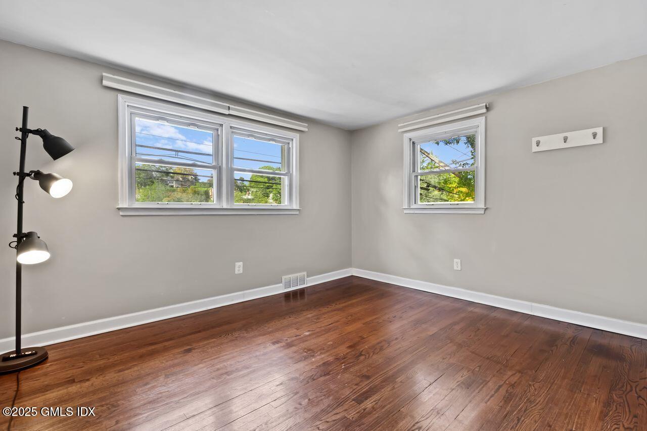207 Sheep Hill Road Riverside, CT 06878 - Photo 10 of 18 a view of an empty room with wooden floor and a window