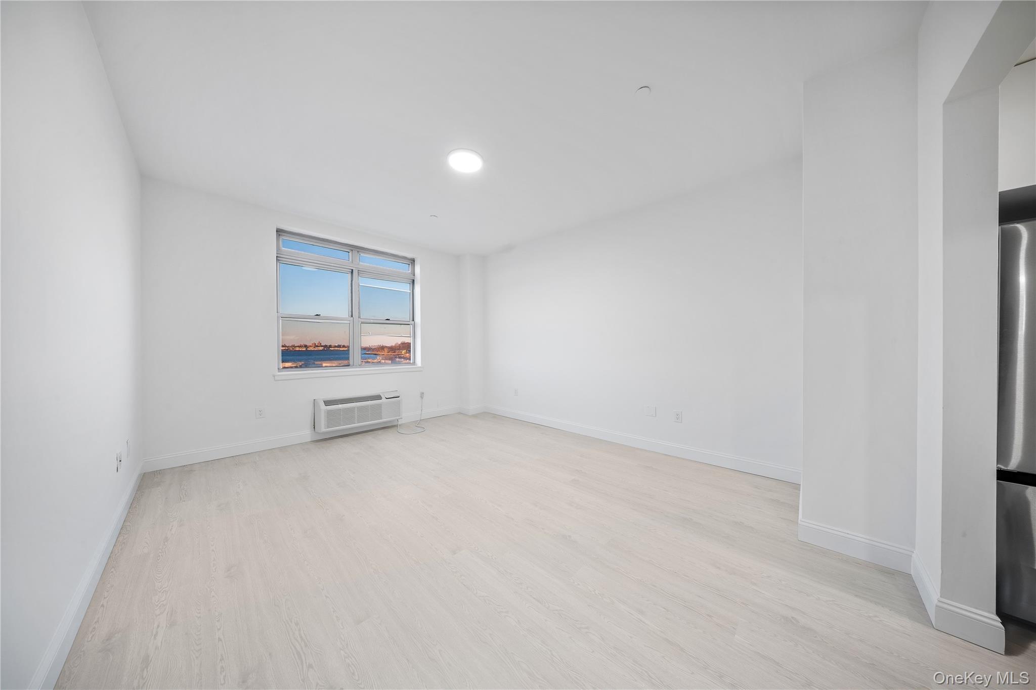 14-34 110th Street, Unit 5I Queens, NY 11356 - Photo 4 of 17 a view of an empty room and a window