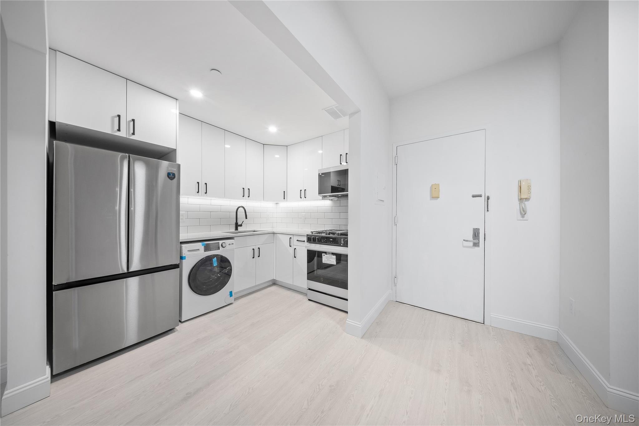 14-34 110th Street, Unit 5I Queens, NY 11356 - Photo 6 of 17 a kitchen with stainless steel appliances a refrigerator and a stove