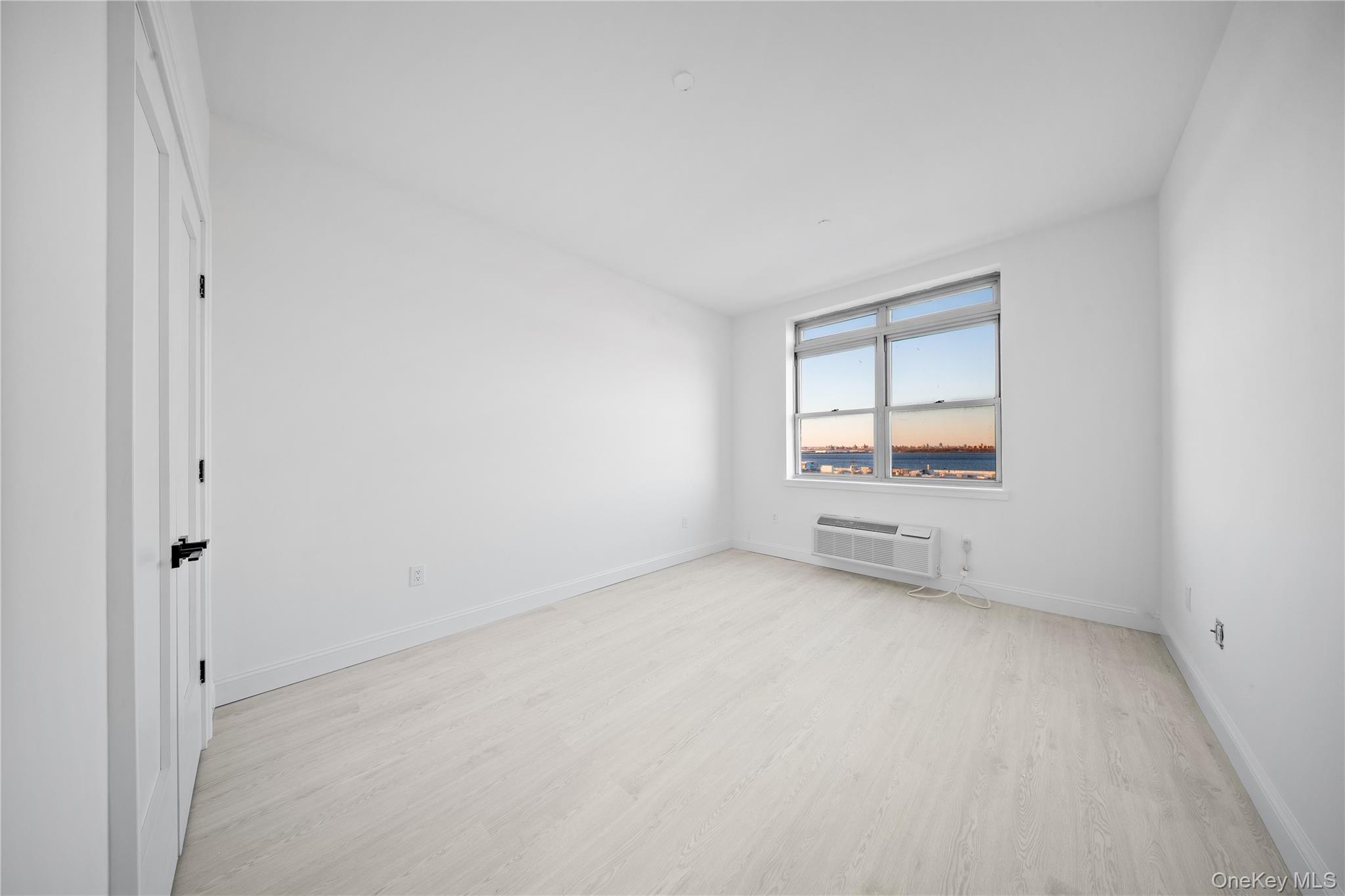 14-34 110th Street, Unit 5I Queens, NY 11356 - Photo 8 of 17 an empty room with a window