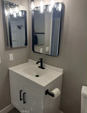 a bathroom with a sink vanity and mirror