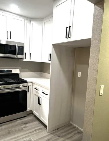 a kitchen with stainless steel appliances granite countertop a stove and a refrigerator