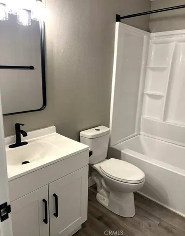 a white toilet sitting next to a bathroom sink