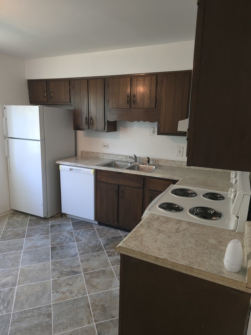 4052 Charleston Road Matteson, IL 60443 - Photo 7 of 10 a kitchen with a sink a stove and refrigerator