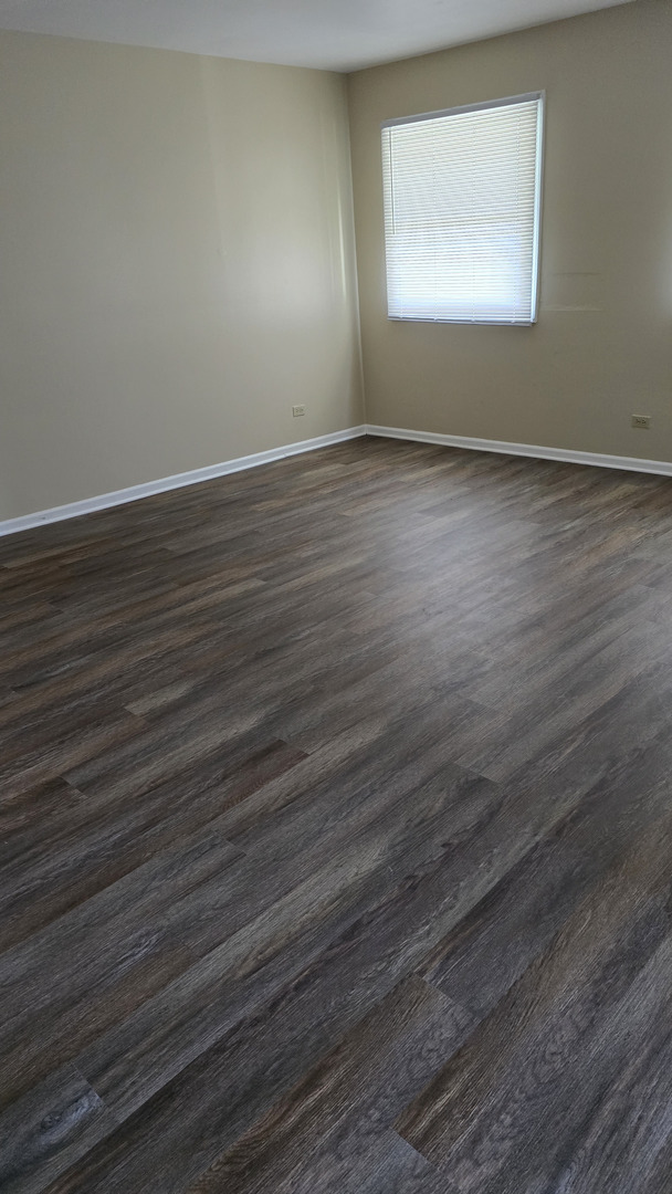 4052 Charleston Road Matteson, IL 60443 - Photo 9 of 10 an empty room with wooden floor and windows
