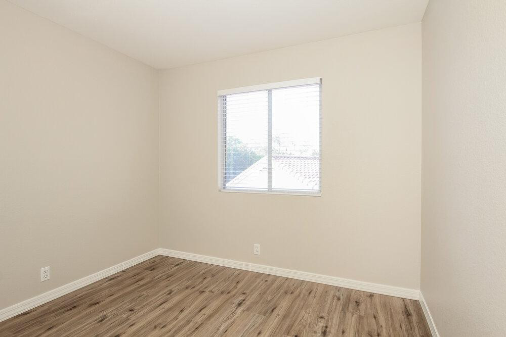 9243 West St John Road Peoria, AZ 85382 - Photo 13 of 17 an empty room with wooden floor and windows