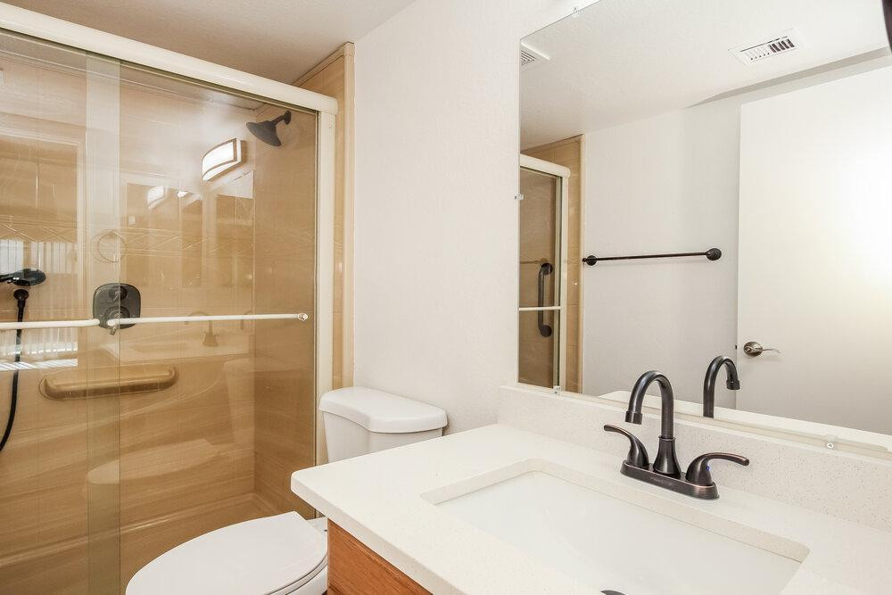 9243 West St John Road Peoria, AZ 85382 - Photo 14 of 17 a bathroom with a sink a toilet and a mirror