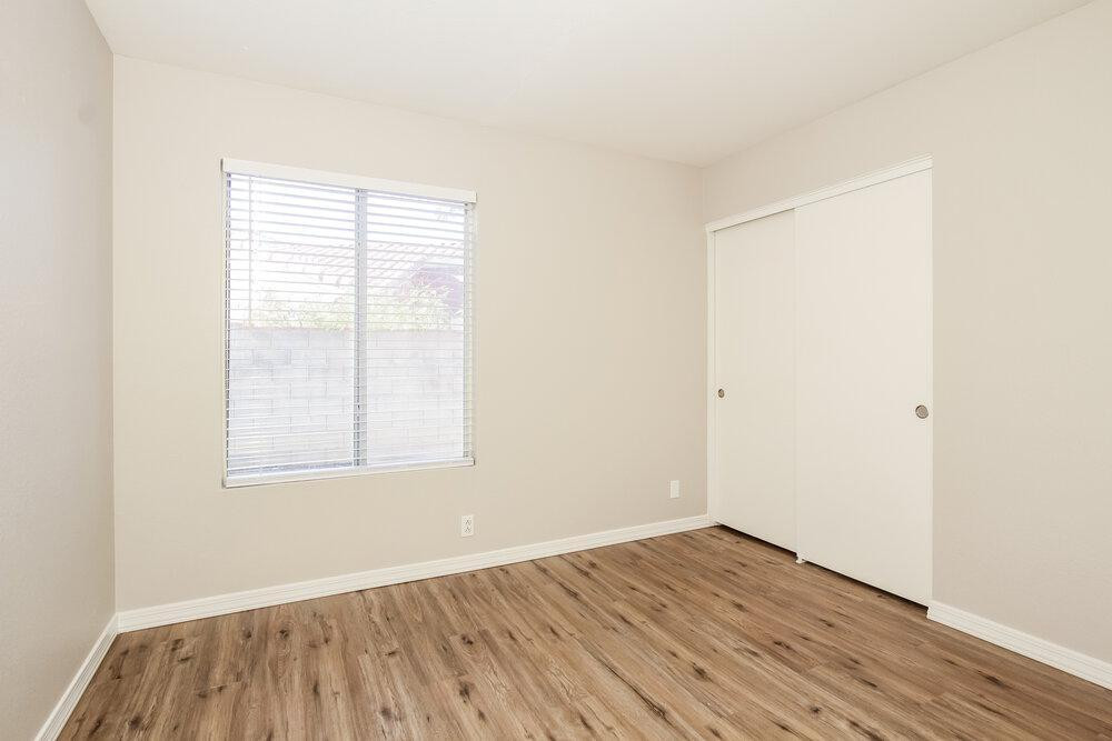 9243 West St John Road Peoria, AZ 85382 - Photo 17 of 17 an empty room with wooden floor and windows