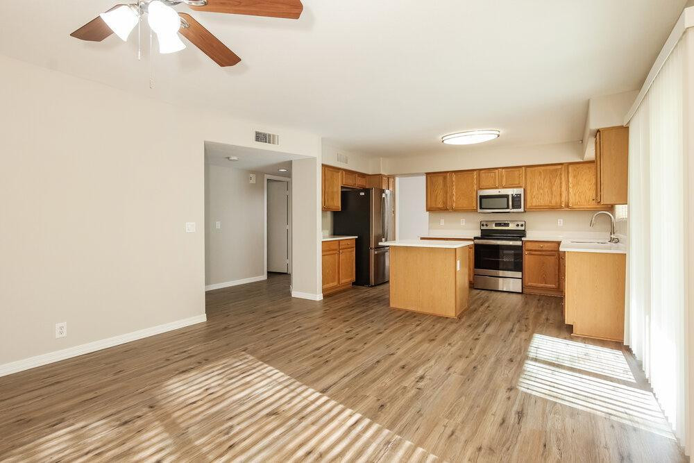 9243 West St John Road Peoria, AZ 85382 - Photo 3 of 17 a kitchen with stainless steel appliances granite countertop a refrigerator and a stove top oven