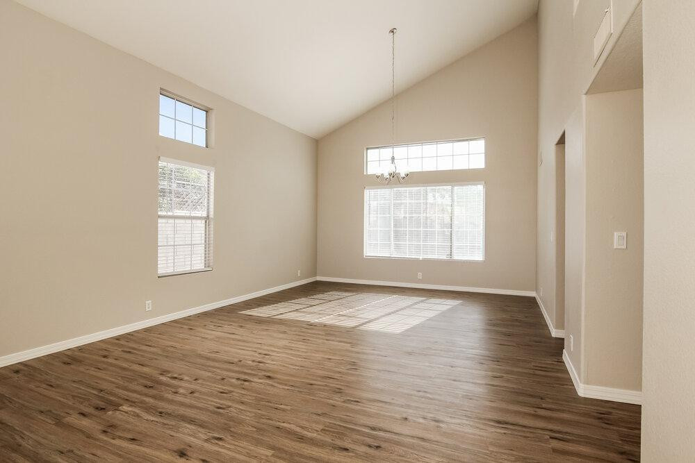 9243 West St John Road Peoria, AZ 85382 - Photo 5 of 17 a view of an empty room with wooden floor and a window