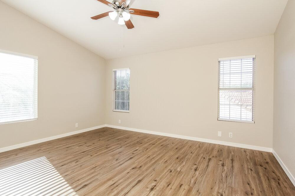 9243 West St John Road Peoria, AZ 85382 - Photo 9 of 17 a view of an empty room with wooden floor and a window