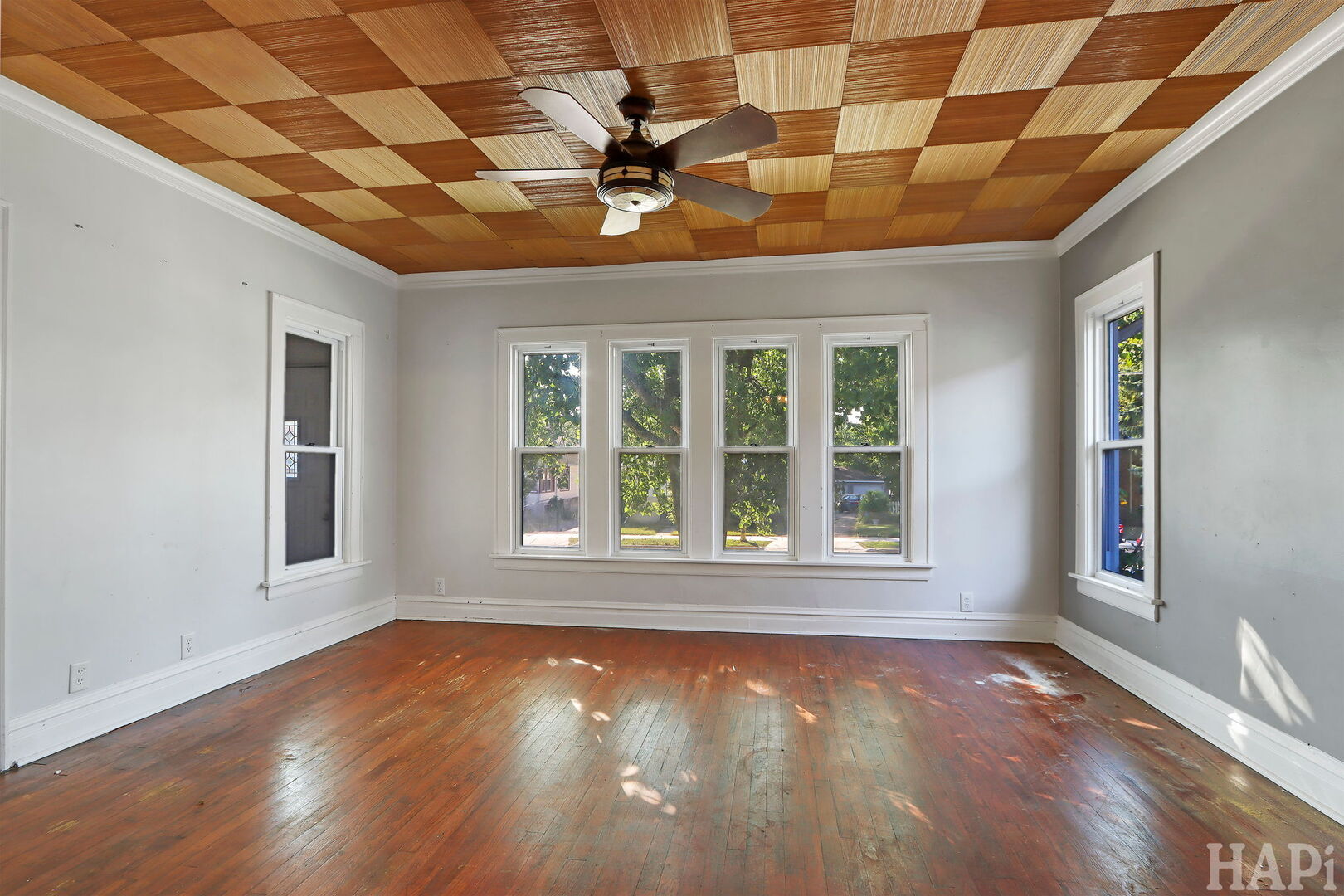 619 North Butrick Street Waukegan, IL 60085 - Photo 2 of 20 a view of an empty room with wooden floor and a window