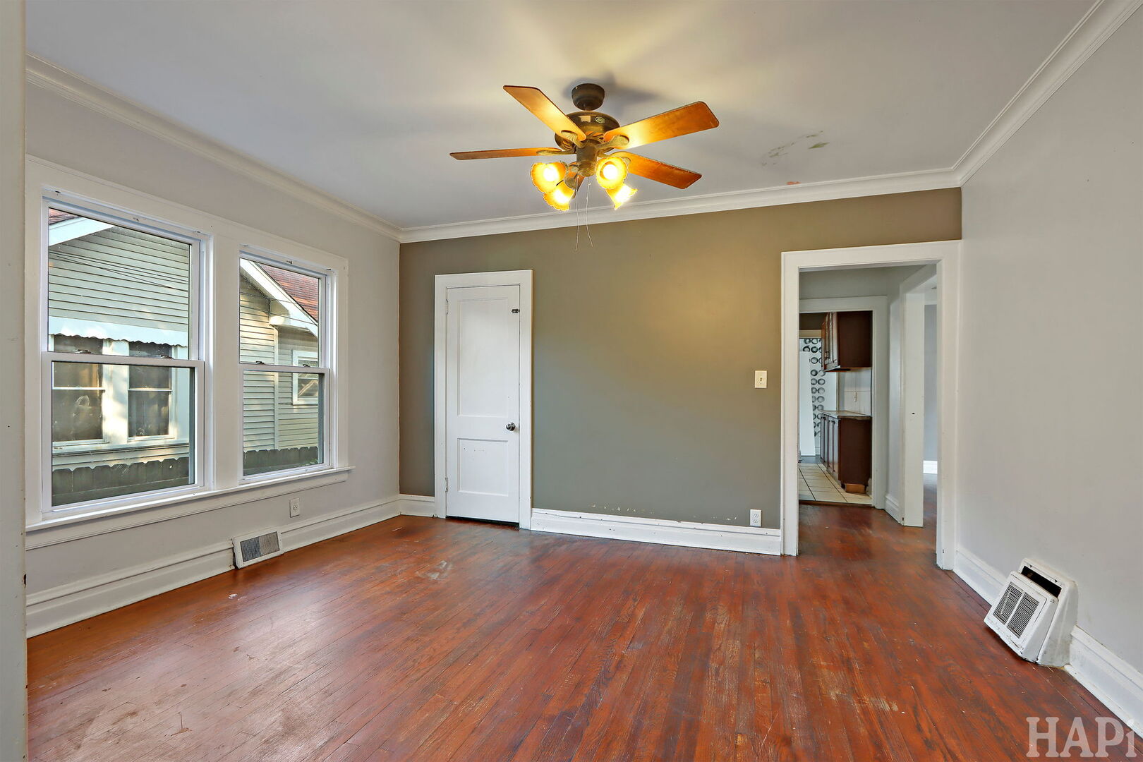 619 North Butrick Street Waukegan, IL 60085 - Photo 4 of 20 a view of an empty room with a window and wooden floor